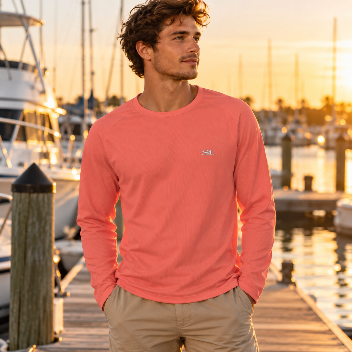 Man wearing Spindrift Coral Sun Shirt in a coastal setting