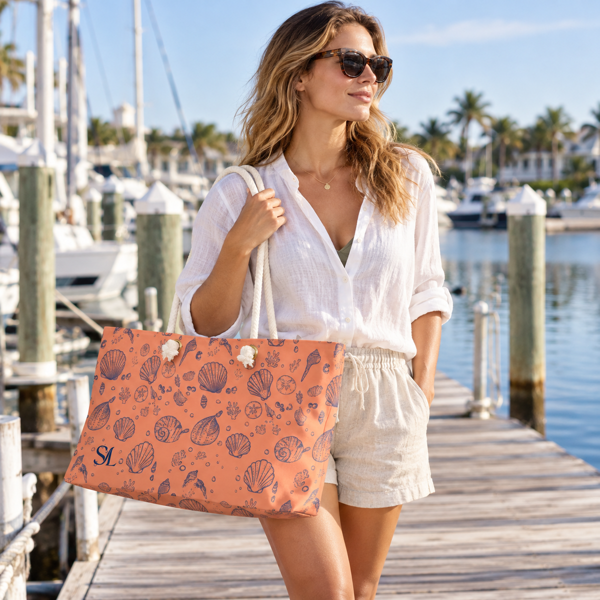 Woman carrying Sunset Shore weekender bag on a marina dock