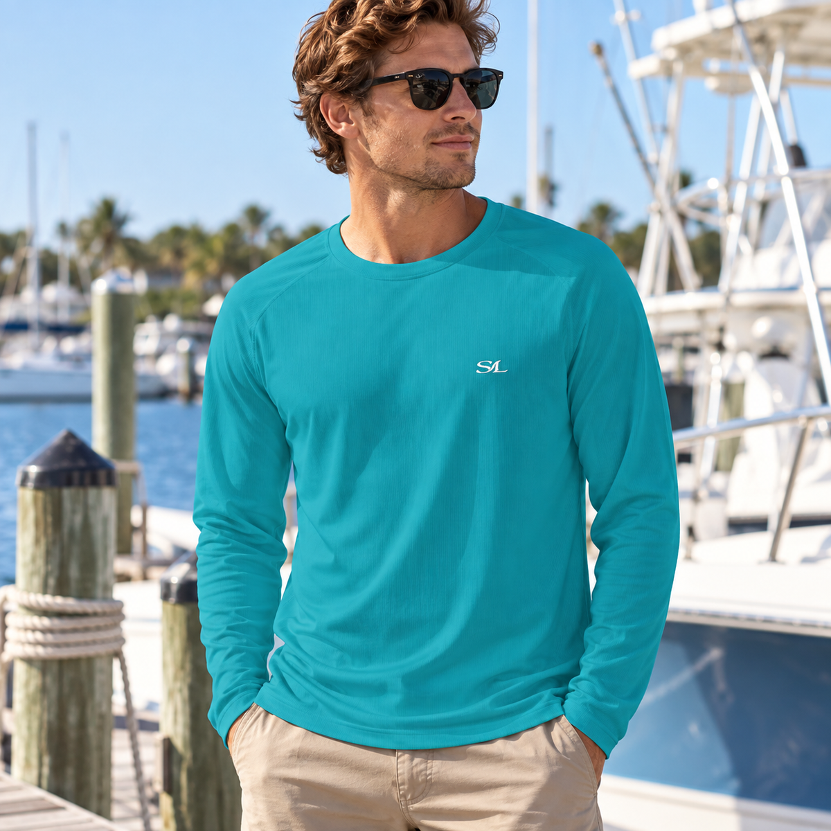 Man wearing Abaco Turquoise Sun Shirt in a coastal setting