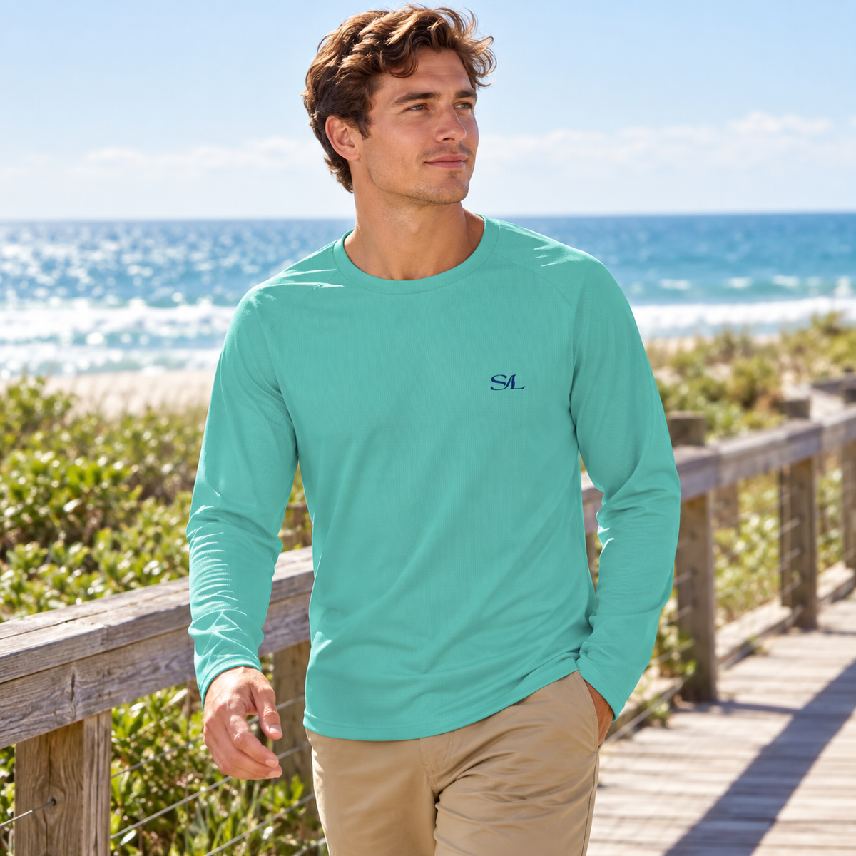 Man wearing Sea Foam Mist Sun Shirt in a coastal setting
