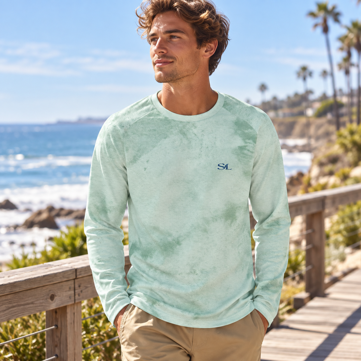 Man wearing Sea Salt Mist Sun Shirt in a coastal setting